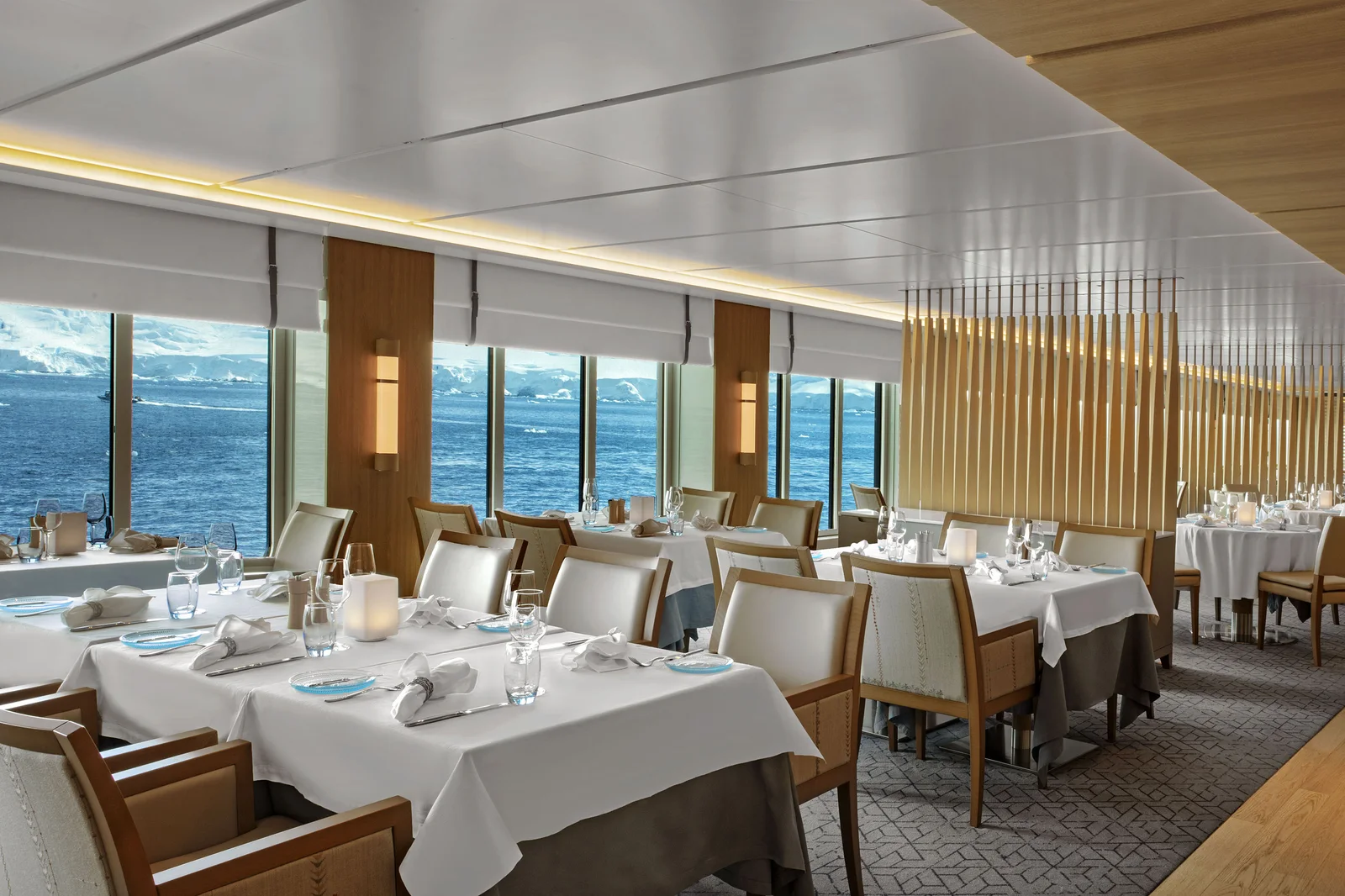 The Restaurant dining room on a Viking ship with panoramic ocean views and crisp white linens